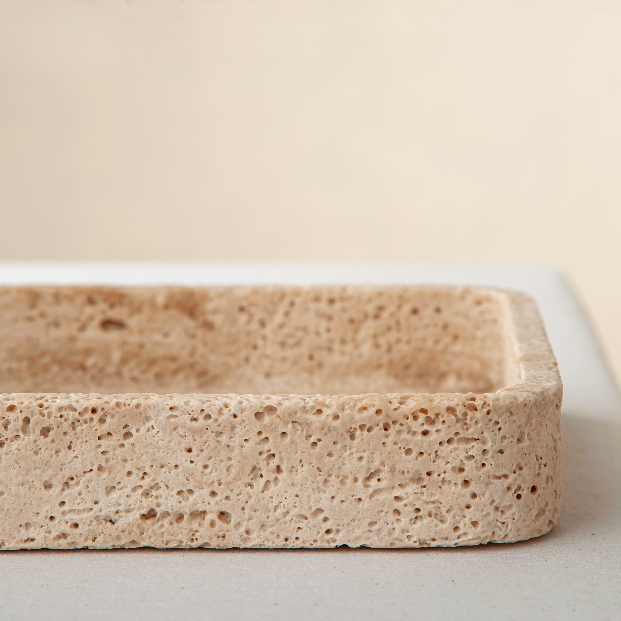 handcrafted travertine tray with porous texture and beige tones for modern decor
