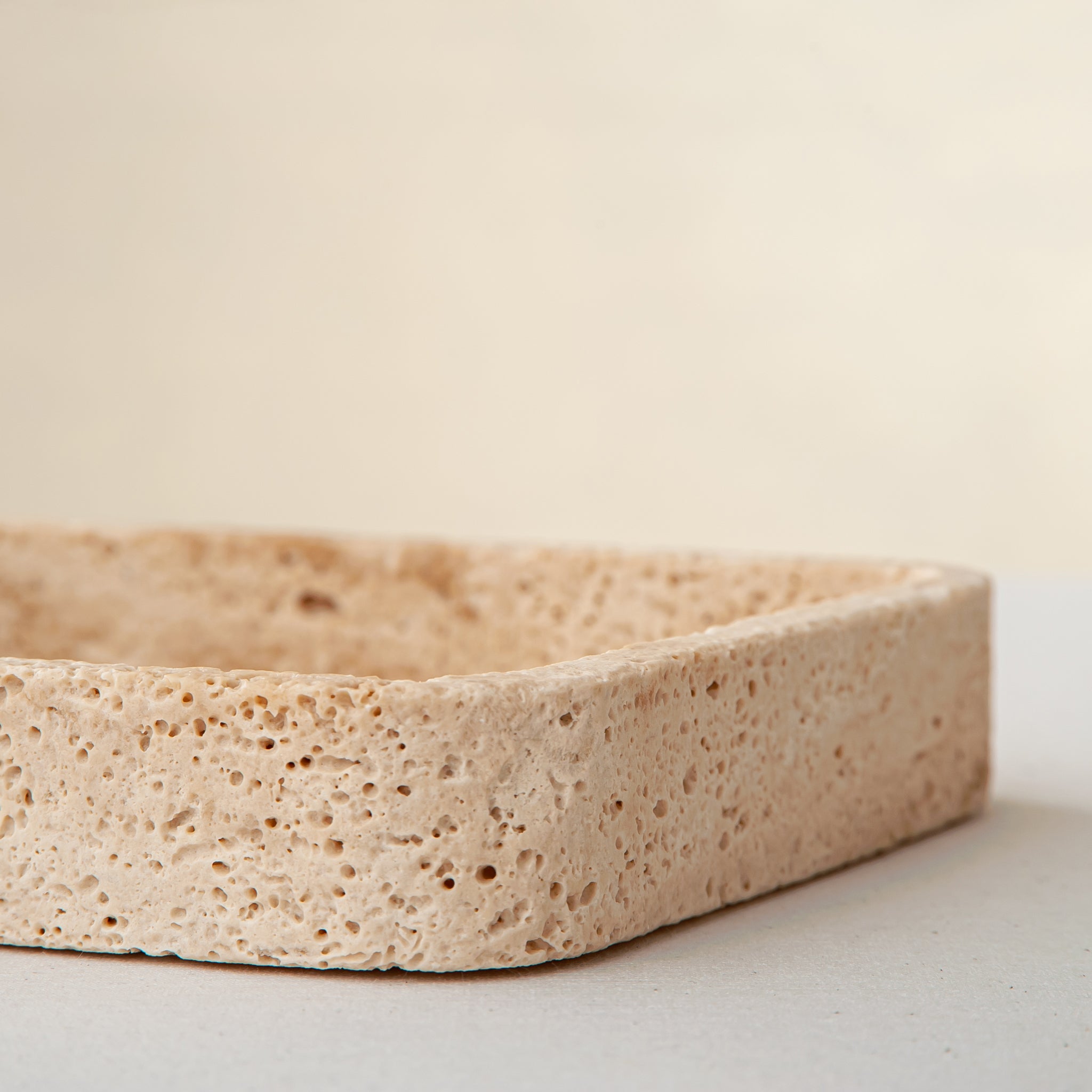 handcrafted travertine tray with porous texture and beige tones for modern decor
