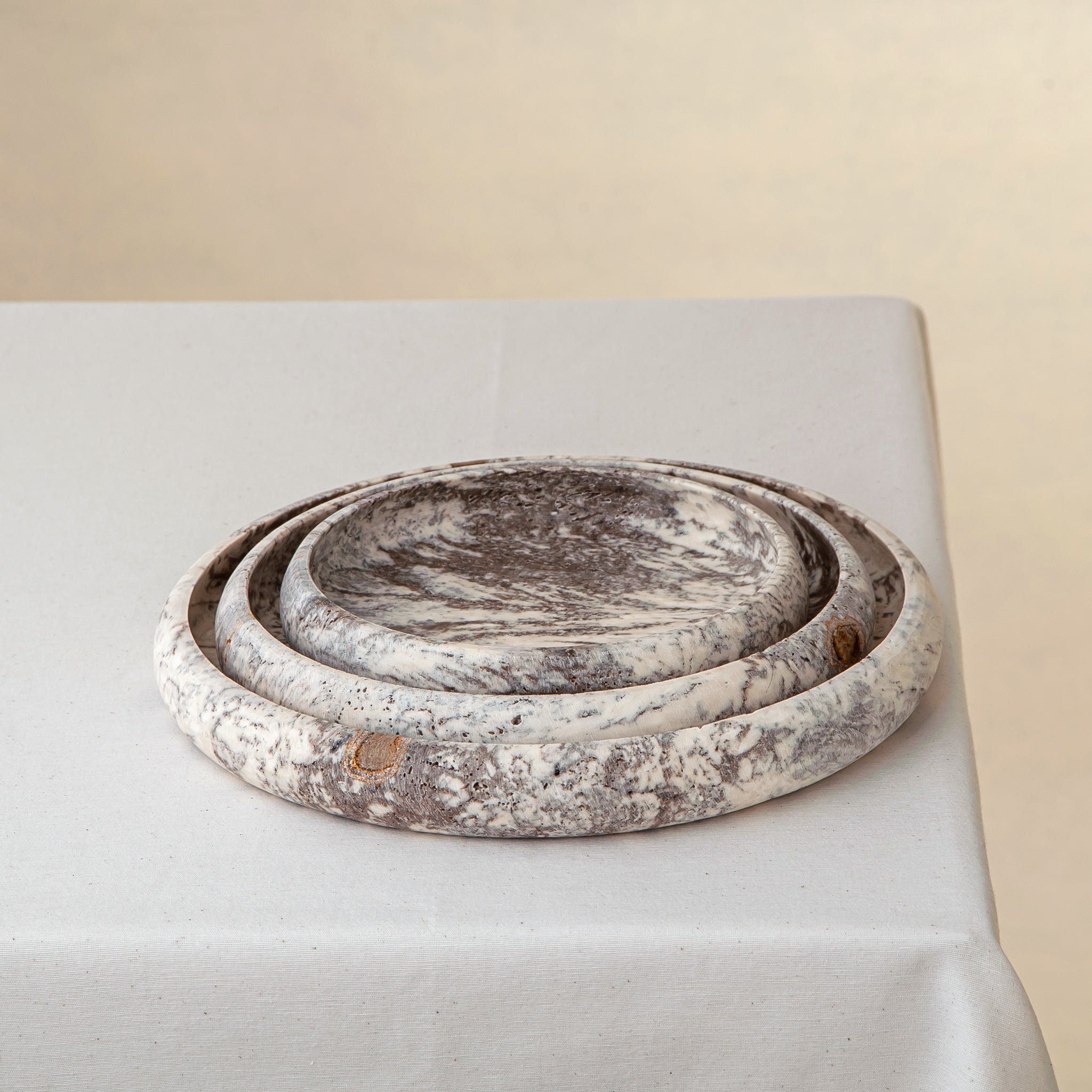 handcrafted travertine tray set of three with layered design and earthy tones for coffee table decor
