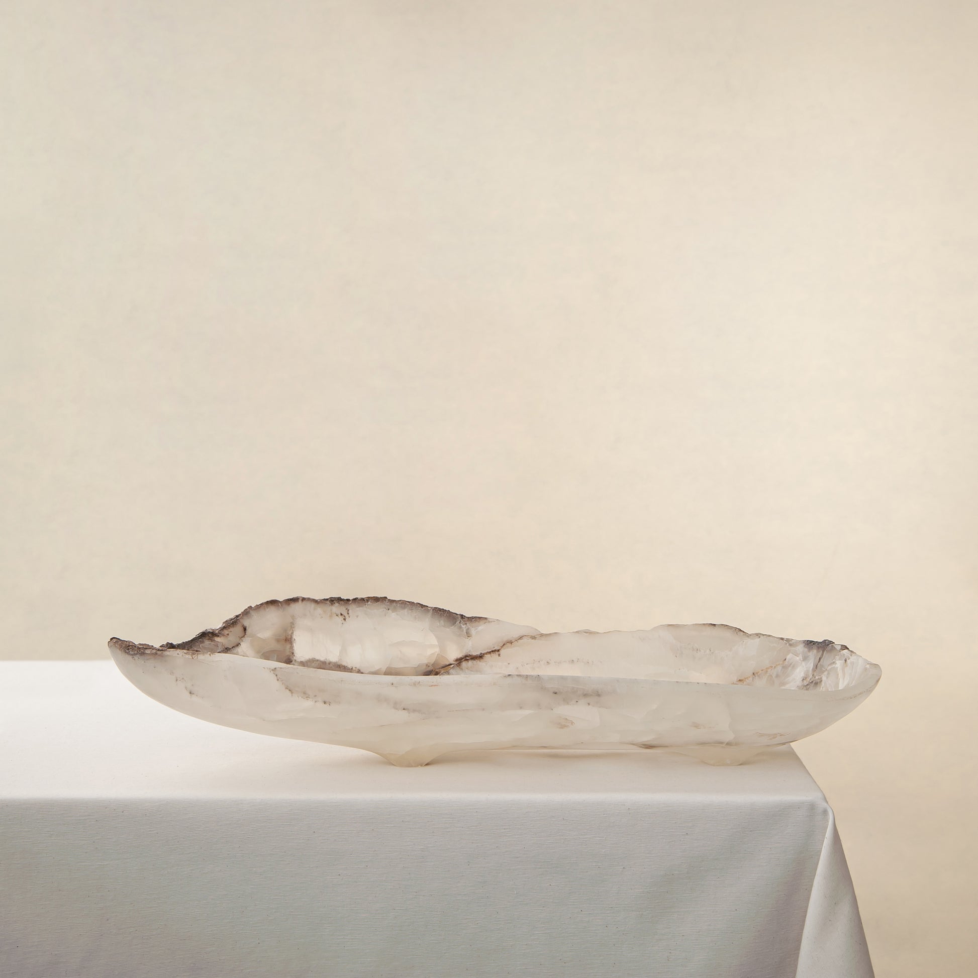 Handcrafted Grotta pale onyx tray with raw, geode-like broken rim, by Uniiqo Studio