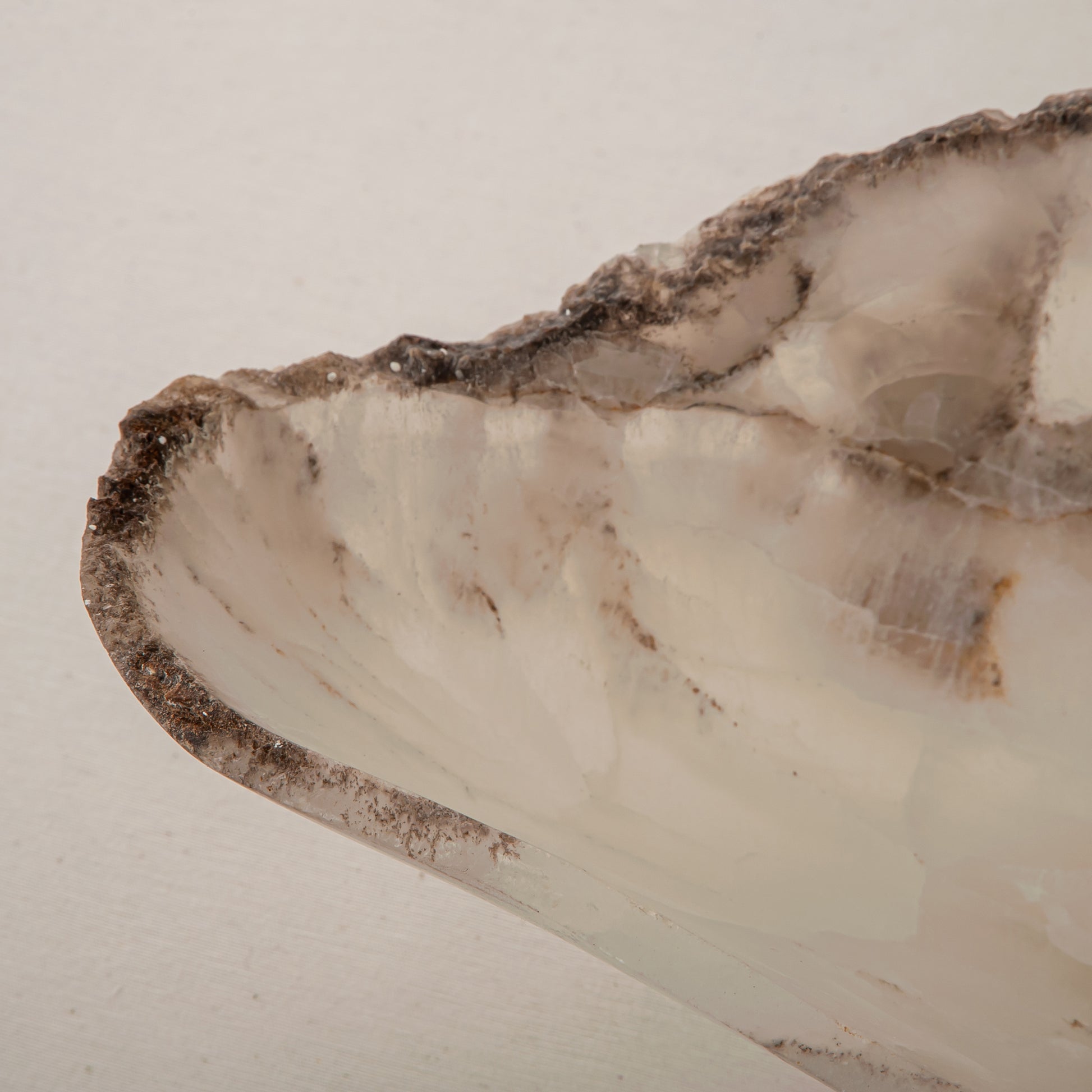Handcrafted Grotta pale onyx tray with raw, geode-like broken rim, by Uniiqo Studio