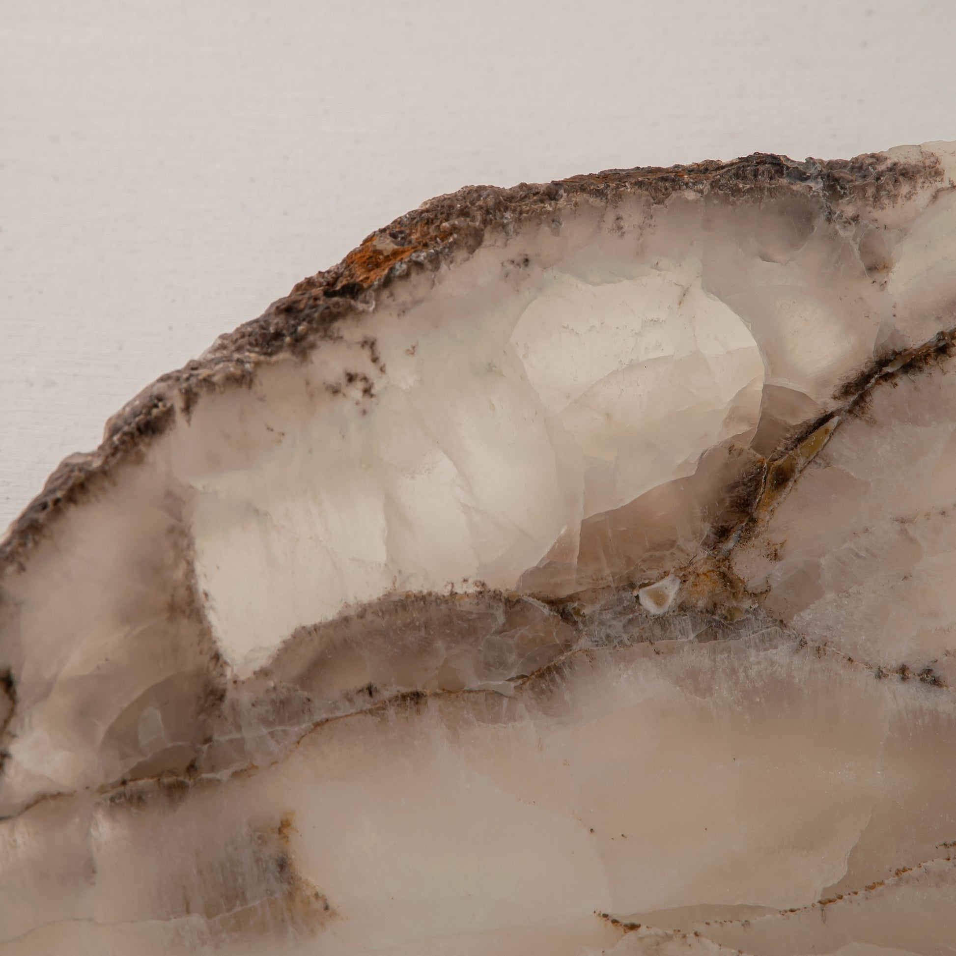Handcrafted Grotta pale onyx tray with raw, geode-like broken rim, by Uniiqo Studio