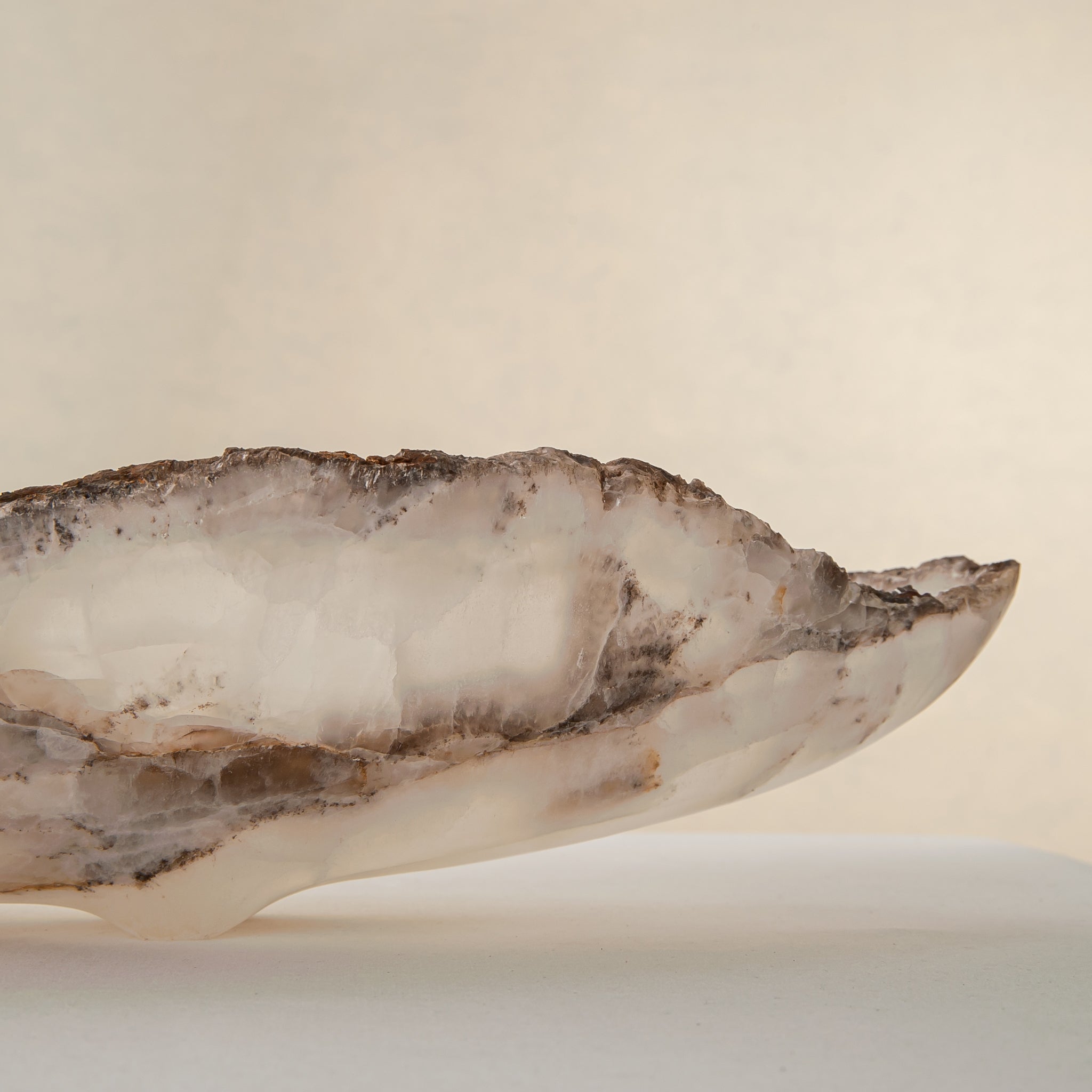 Handcrafted Grotta pale onyx tray with raw, geode-like broken rim, by Uniiqo Studio