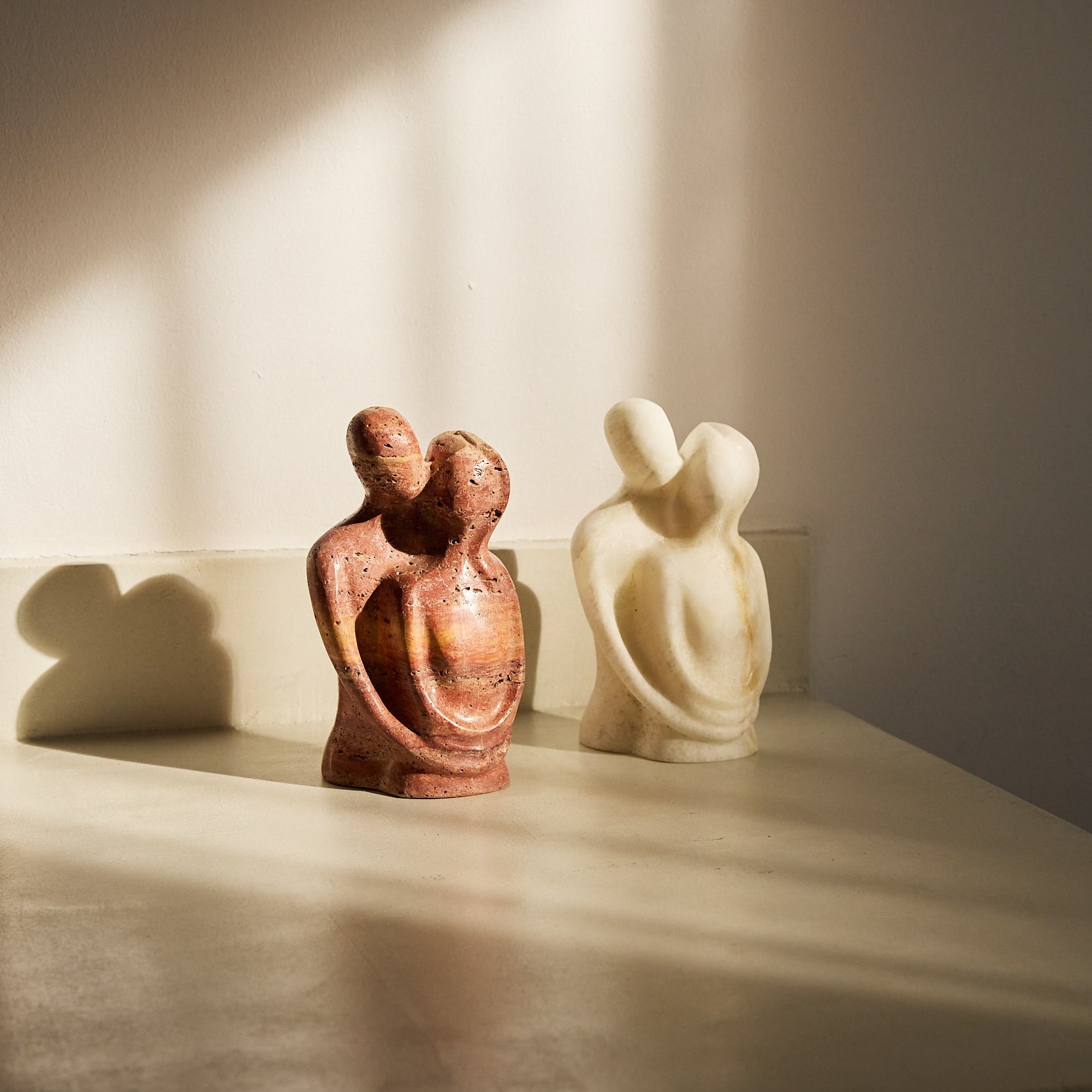 Marble and travertine sculptures, hugging.