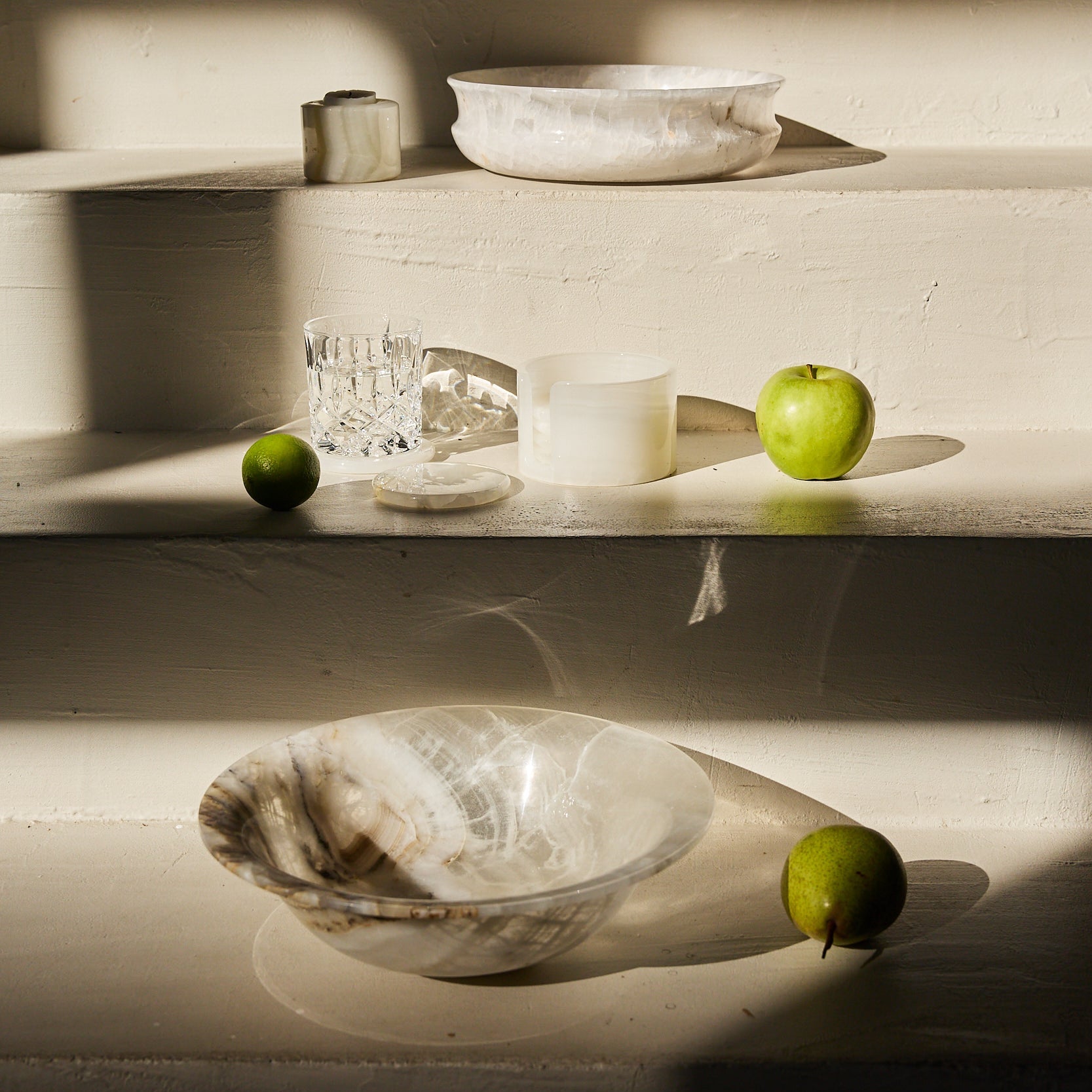 Unique white onyx bowl with translucent layered veining and handcrafted finish
