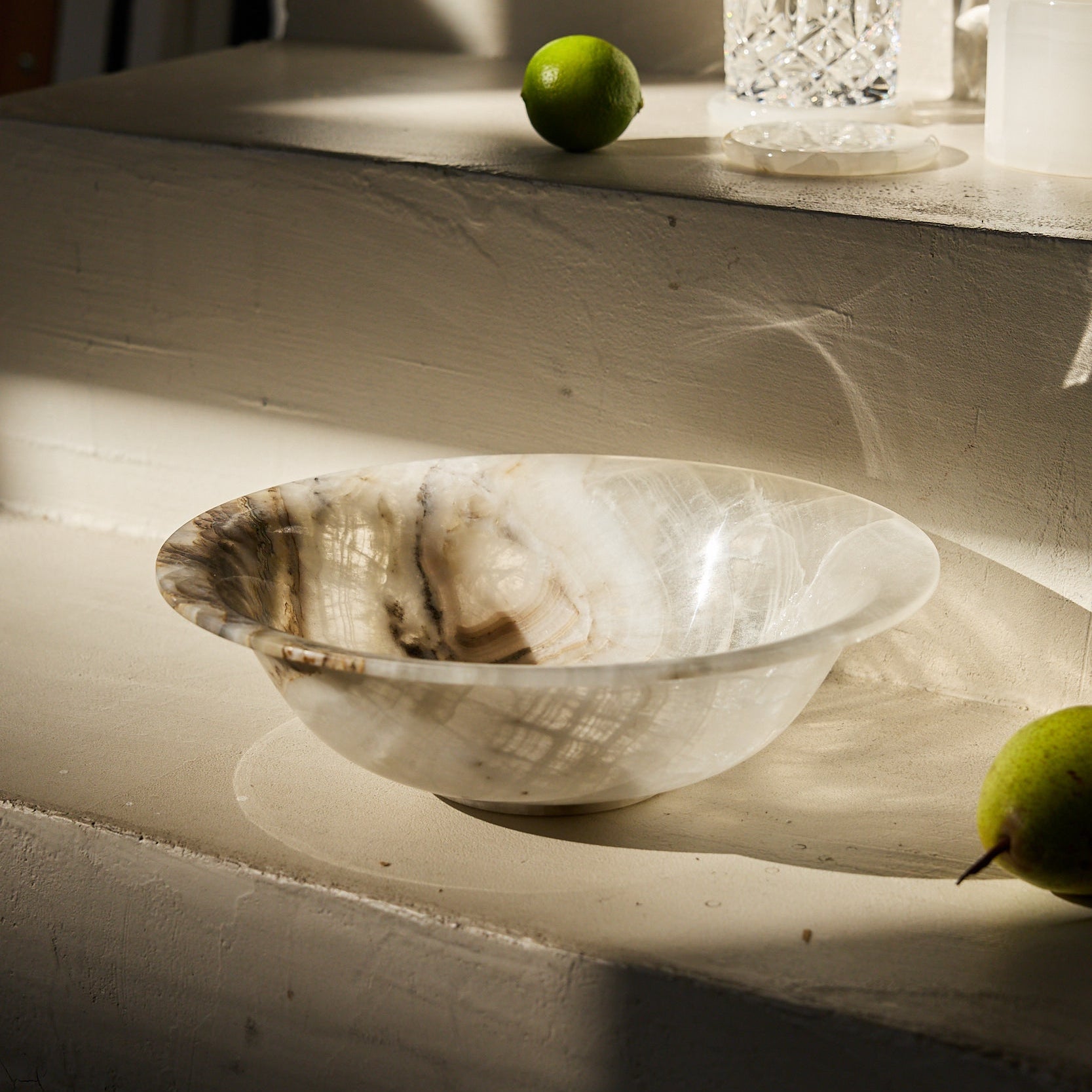 Unique white onyx bowl with translucent layered veining and handcrafted finish
