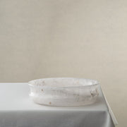 Unique white onyx bowl with translucent stone texture and sculptural curved form

